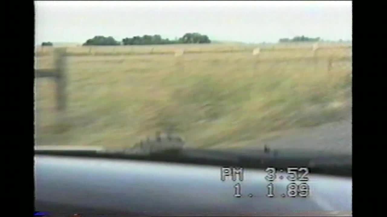 Video thumbnail showing: Snake is on hood of car while man & woman are driving